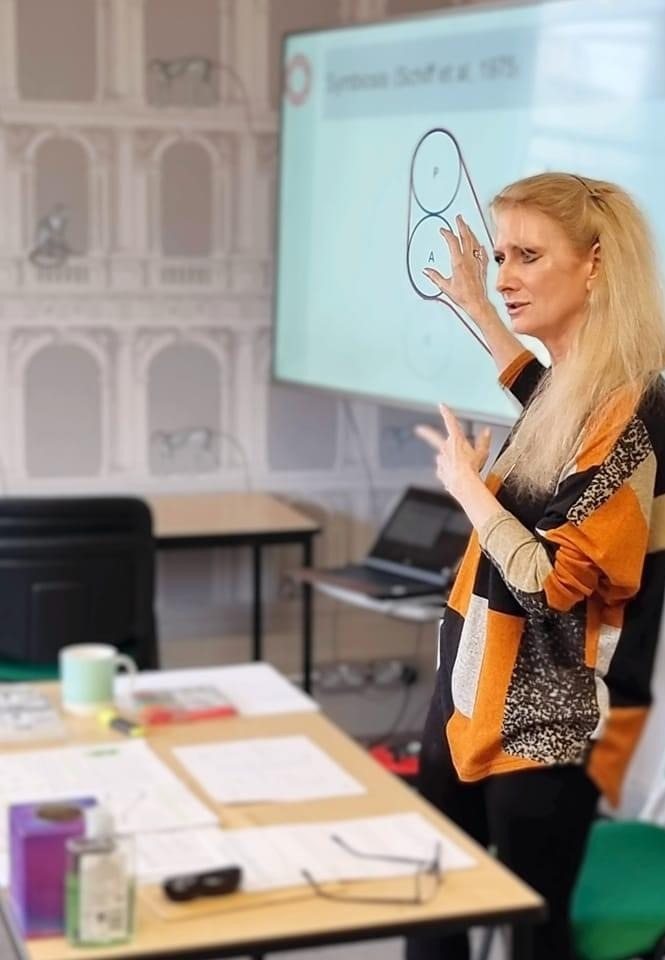 Lisa Bedford-Cooper teaching, pointing to a diagram of ego states